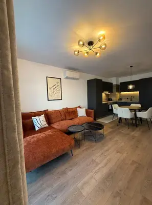 a living room with a couch and a dining room at Modern 2 Bedroom - 2 Baths - Private Garage Free in Center in Sofia