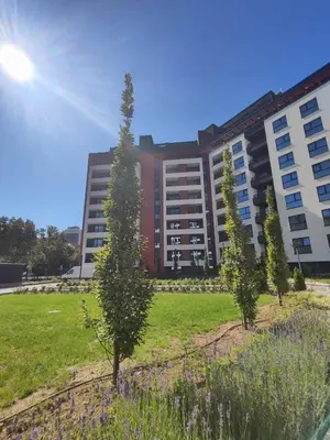 a large building with trees in front of it at Modern 2 Bedroom - 2 Baths - Private Garage Free in Center in Sofia