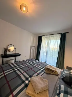 a bedroom with a bed with two towels on it at Modern 2 Bedroom - 2 Baths - Private Garage Free in Center in Sofia