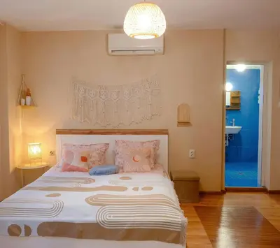 a bedroom with a large bed with pink pillows at Dream Hill Nest-Boho Vintage Hideaway in Plovdiv