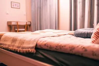 a bed with a blanket on it in a room at Dream Hill Nest-Boho Vintage Hideaway in Plovdiv