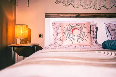 a bedroom with a large white bed with a pillow at Dream Hill Nest-Boho Vintage Hideaway in Plovdiv