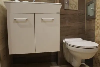 a bathroom with a white toilet and a sink at cosy apartment in Sofia