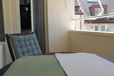 a room with a table and a chair and a window at cosy apartment in Sofia