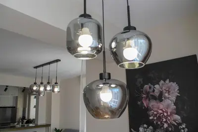 a group of five lights hanging from a ceiling at cosy apartment in Sofia