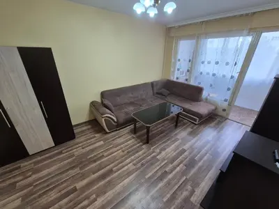a living room with a leather couch and a glass table at Mladost stay apartment in Sofia