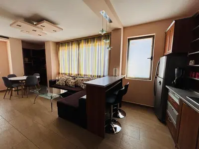 a kitchen and living room with a couch and a table at Cozy 1-Bedroom Apartment Near Old Town - Purple5 in Plovdiv