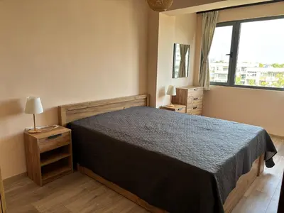 a bedroom with a bed and a large window at Cozy 1-Bedroom Apartment Near Old Town - Purple5 in Plovdiv