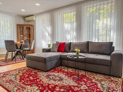 a living room with a couch and a red rug at Two-Bedroom Central and Cosy Apartment in Plovdiv