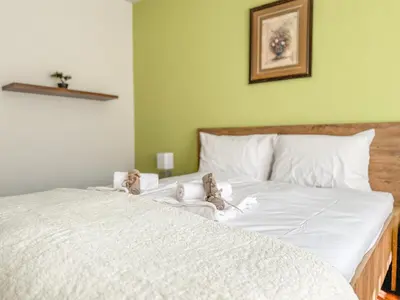 a bed with two stuffed animals sitting on top of it at Two-Bedroom Central and Cosy Apartment in Plovdiv