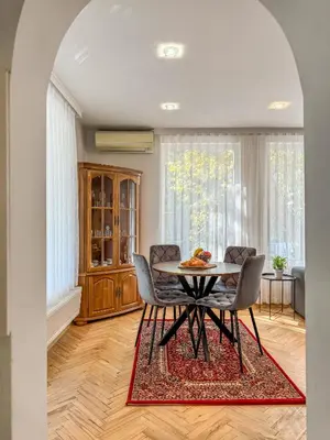 a dining room with a table and chairs at Two-Bedroom Central and Cosy Apartment in Plovdiv