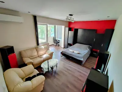 a living room with a couch and a table at Sunny Corner Apartment in Plovdiv