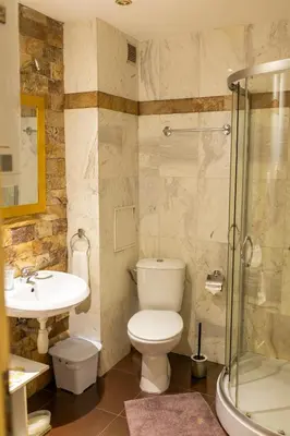 a bathroom with a toilet and a sink and a shower at Megy's 3 Bedroom Central Apartment near NDK in Sofia