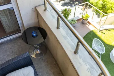 a balcony with a table and a railing at Megy's 3 Bedroom Central Apartment near NDK in Sofia