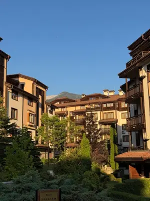 a group of buildings with trees in front of them at The Bansko Retreat in Bansko