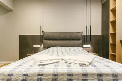 a bed with two white towels on top of it at Apartment in Sofia's core - NDK in Sofia