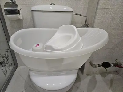 a white toilet in a bathroom with a sink at Deva Apartments in Sandanski