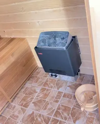 a dog crate sitting on the floor in a room at Къща за Гости Тодор in Shiroki Dol