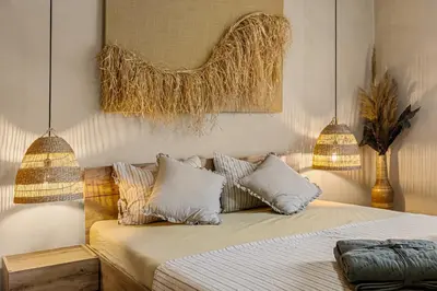 a bedroom with a bed with two pillows and aigunigunigun at Villa YASNA - Art of slow living in Sredno Gradishte