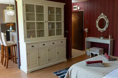 a bedroom with a large white cabinet and a bed at Megy's Top Central Studio Next to NDK in Sofia