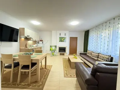 a living room with a couch and a table at Apartment Grand Monastery Pamporovo in Pamporovo