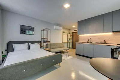 a large bedroom with a bed and a kitchen at La Shara Building in Sofia