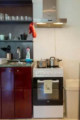 a kitchen with a stove with pots and pans on it at Megy's 3rd Top Central Room in Sofia