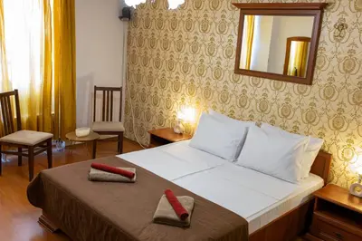 a bedroom with a bed with two slippers on it at Megy's 2nd Top Central Room in Sofia
