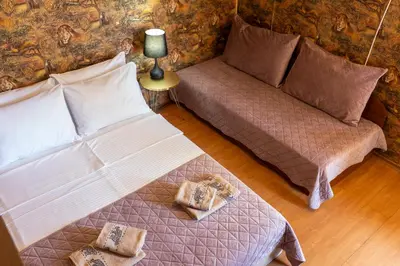 a living room with a bed and a couch at Megy's 1st Room next to the National Palace of Culture in Sofia