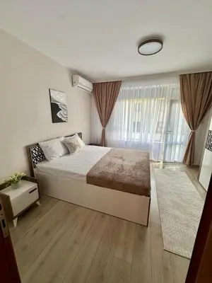 a bedroom with a large bed and a large window at The Central Suite in Petrich