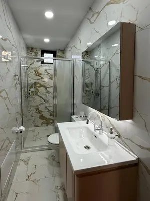 a bathroom with a sink and a shower and a toilet at Asen Tsvetkov Apartment in Sandanski