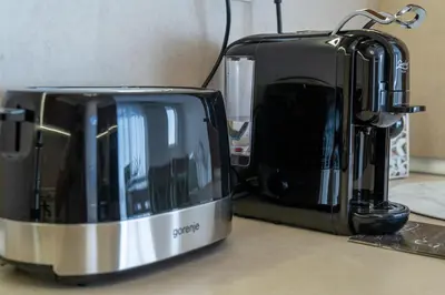 a toaster and coffee maker sitting on a counter at Evgeny's Stylishly Designed 2 Bedroom Apartment plus Garage! in Sofia