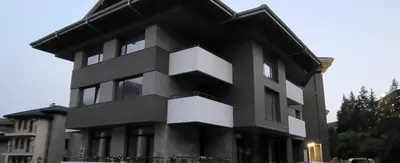 a black and white building with people in front of it at Green apartment Velingrad in Velingrad