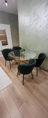 a dining room with a glass table and chairs at Green apartment Velingrad in Velingrad