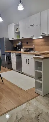 a kitchen with white cabinets and a counter top at Green apartment Velingrad in Velingrad