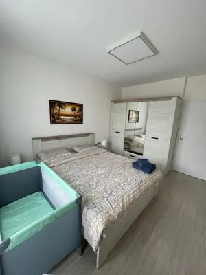 a bedroom with a large bed and a mirror at Well Equipped New Family Friendly One-Bedroom Flat in Sandanski