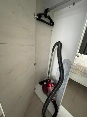 a bathroom with a hose in the corner of a room at Well Equipped New Family Friendly One-Bedroom Flat in Sandanski