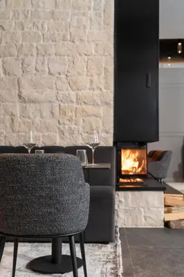 a dining room with a table and a fireplace at Villa Rossa Luxury & Spa Residence in Narechenski Bani