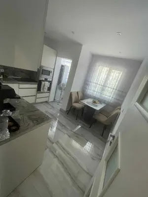 a kitchen and living room with a table and a dining room at 2 Bedroom apartment in Gotse Delchev