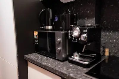 a microwave sitting on top of a counter at 1 minute to main Street & NDK & Free Parking in Sofia
