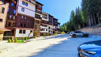 a car parked on a street next to a building at Tulip Studio Deluxe, Grand Resort Pamporovo in Pamporovo