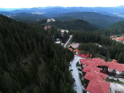 an aerial view of a town in a forest at Tulip Studio Superior, Grand Resort Pamporovo in Pamporovo