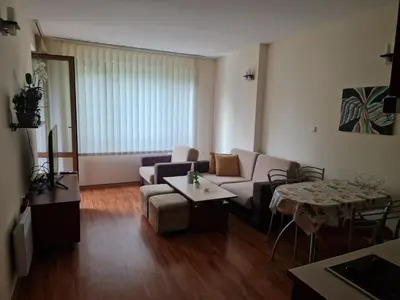 a living room with a couch and a table at Cedar Heights 1 Виванко А7 in Pamporovo
