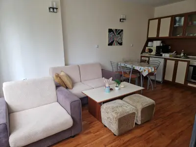 a living room with a couch and a table at Cedar Heights 1 Виванко А7 in Pamporovo