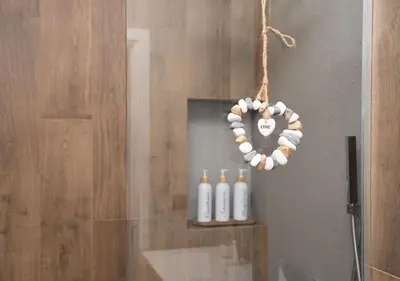 a heart made out of seashells hanging from a shower stall at FS Apartments Kapana Boutique Family Stay in Plovdiv