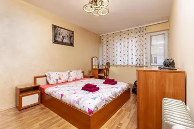 a bedroom with a bed with red towels on it at Comfort Corner - 1BD with Balcony by Flat Mаnager in Plovdiv