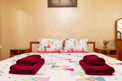 a bed with purple pillows on top of it at Comfort Corner - 1BD with Balcony by Flat Mаnager in Plovdiv