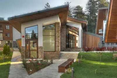 a building with a bench in front of it at White & Wood Suite C302, at Euphoria SPA Borovets in Borovets