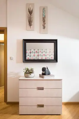 a dresser with a mirror on a wall at Alexandra's City Center Apartment I in Sofia