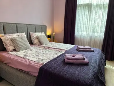 a bed with two towels sitting on top of it at Central Family Residence in Sofia